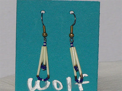 Two short quills and the two long quills all connected with Egg Shell and Navy blue size thirteen cut glass beads. Ear attachment is French Hooks